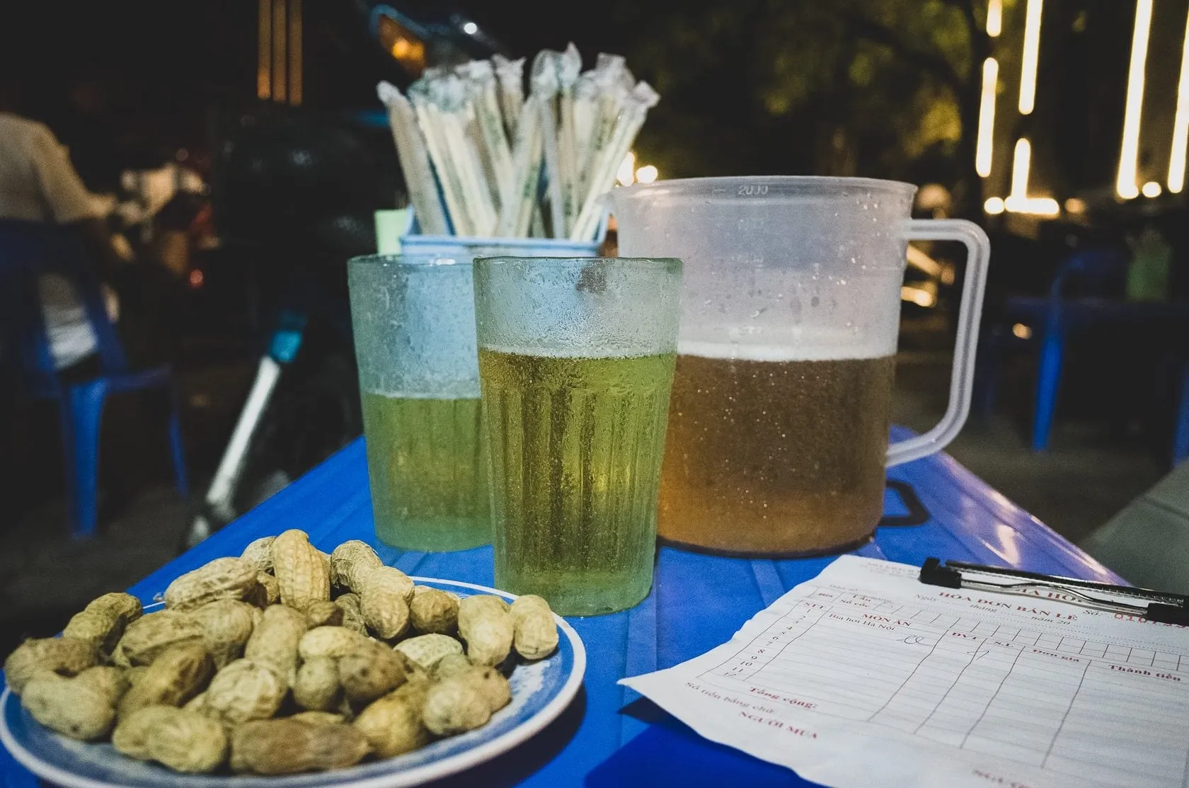 Bia hoi glasses filled with beer on a Hanoi street table
